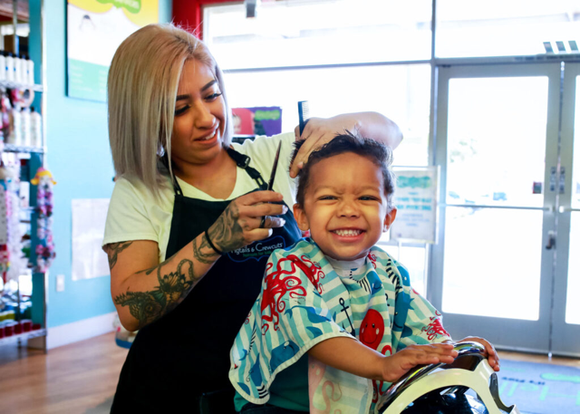 Stylist giving a child a fun haircut at Desirable Beauty Boutique in Teaneck, NJ